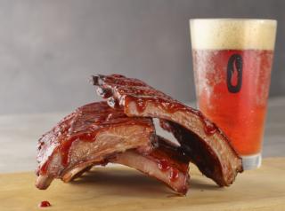 Baby back rib stack with barbecue sauce and a beer from Smokey Bones.