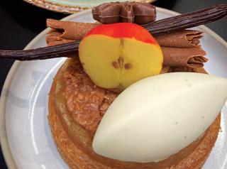 A Dutch apple pie with cinnamon, cream, and caramel is topped off with a 3D printed chocolate apple, made at Unilever's global Food Innovation Center.