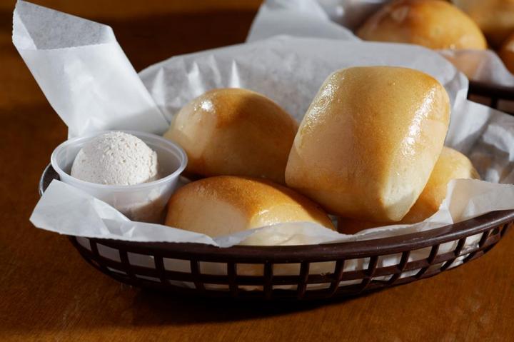 Bread and butter at Texas Roadhouse, served in a basket.